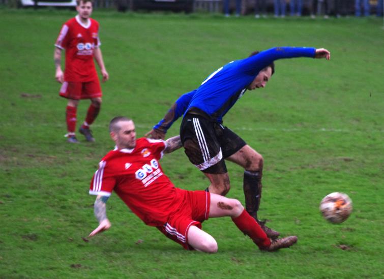 West Dragons player manager Chris Hughes tackles Hakins Ryan Wilson.